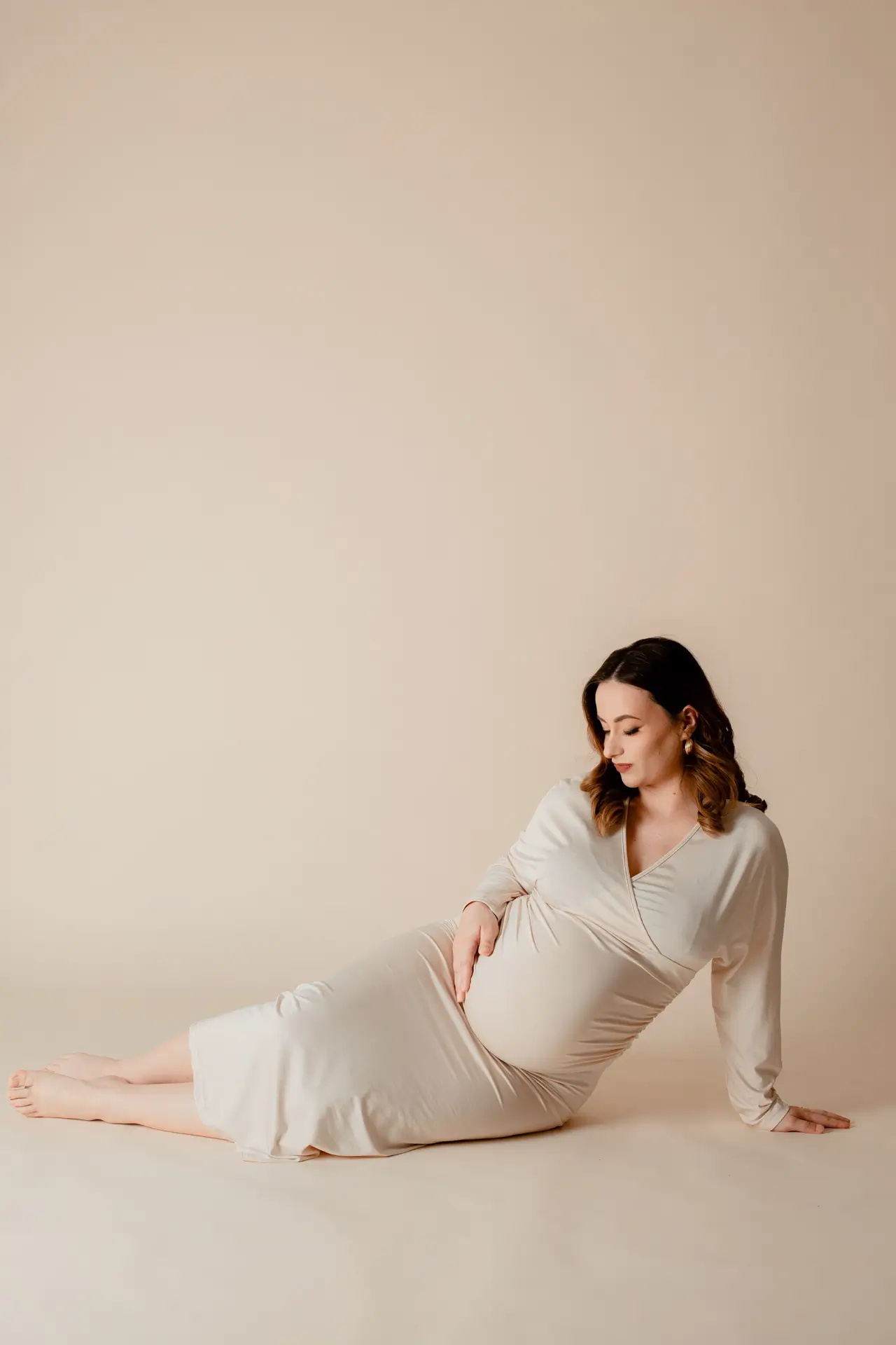 Pregnant woman in a soft, elegant dress