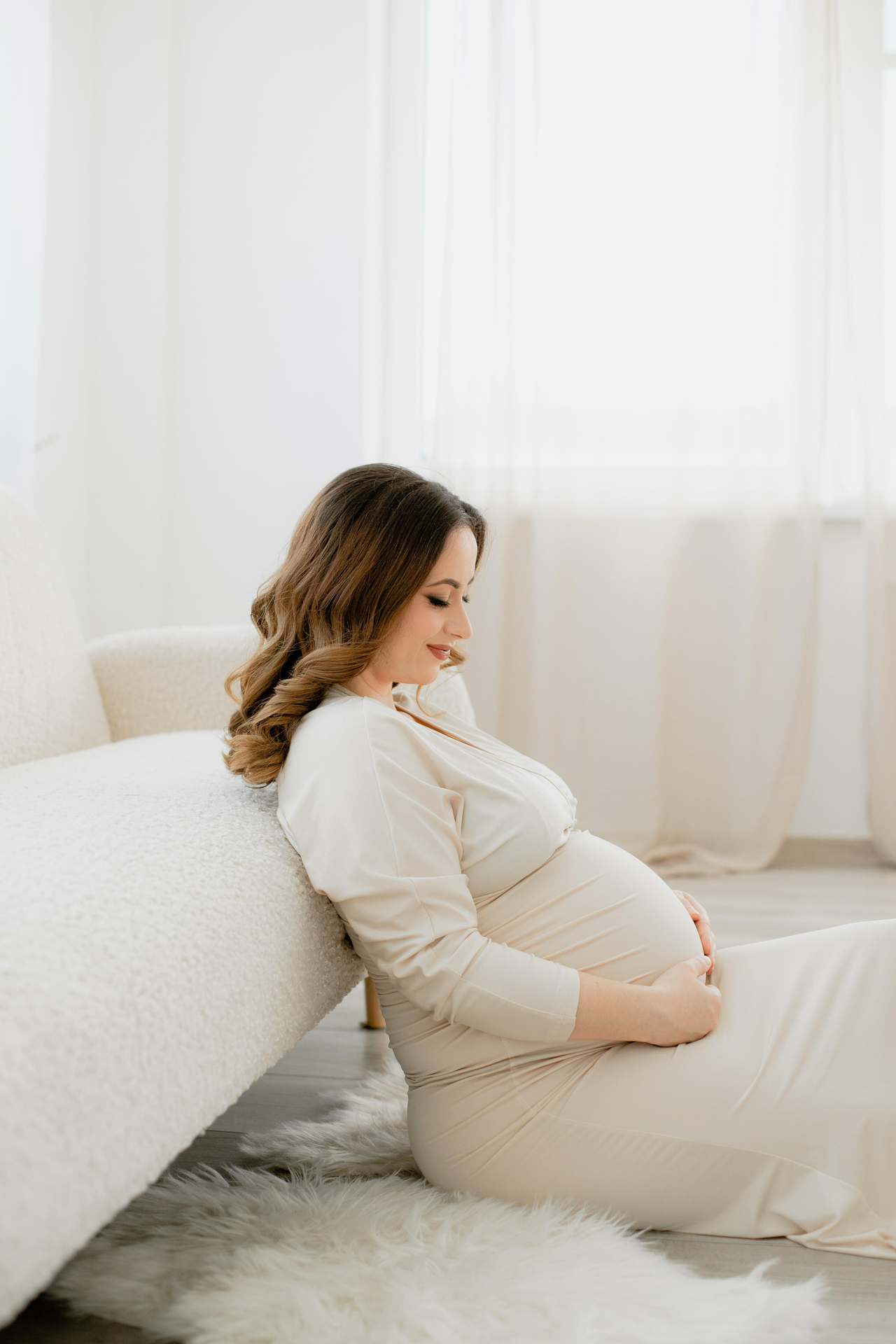 Pregnant woman in a soft, elegant dress